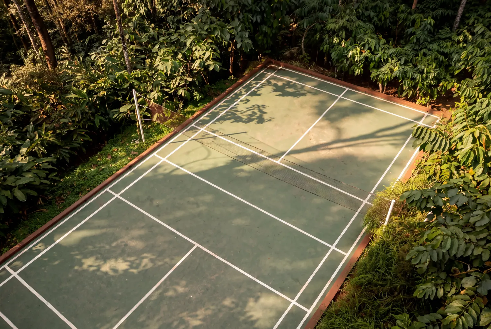 Badminton court surrounded by greenery at Willow Resort
